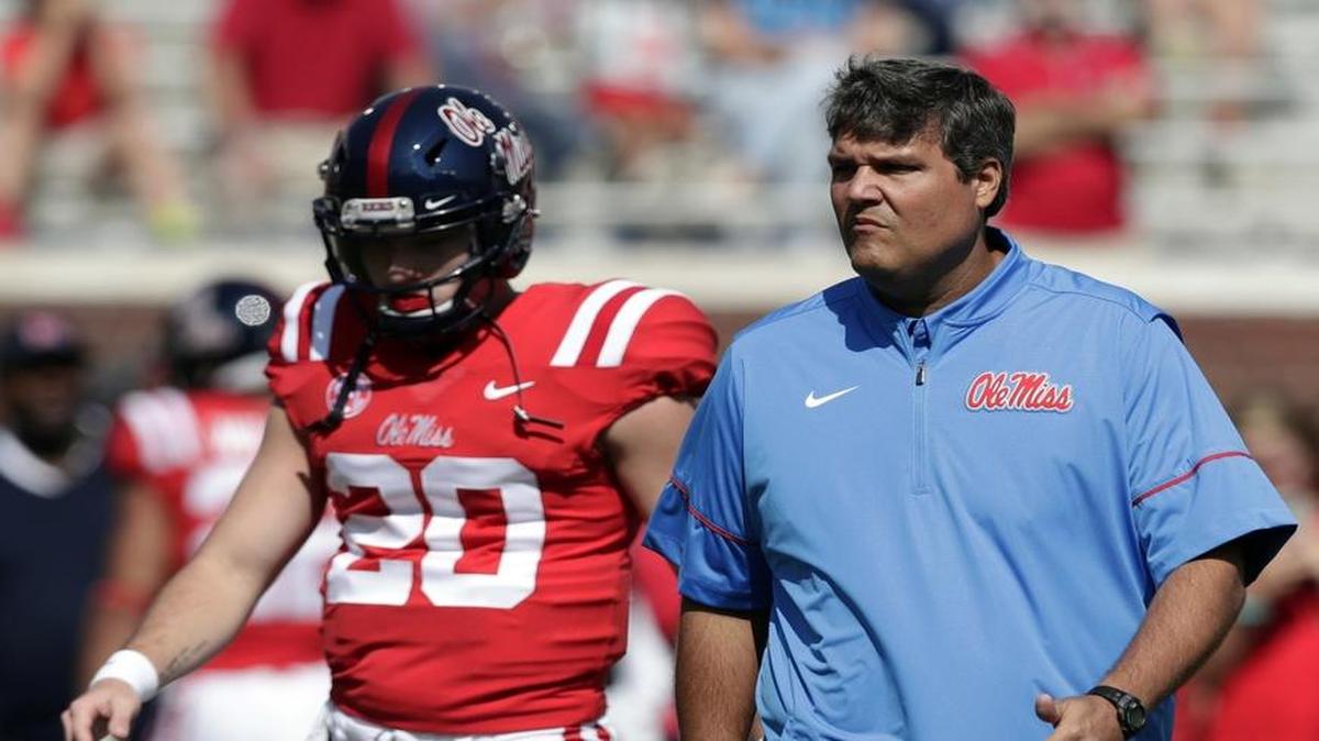 Ole Miss quarterback Shea Patterson (20) walks with interim football coach Matt Luke during a pregame drills before a game against UT Martin in Oxford, Miss., Saturday, Sept. 9, 2017.(AP Photo/Rogelio V. Solis)