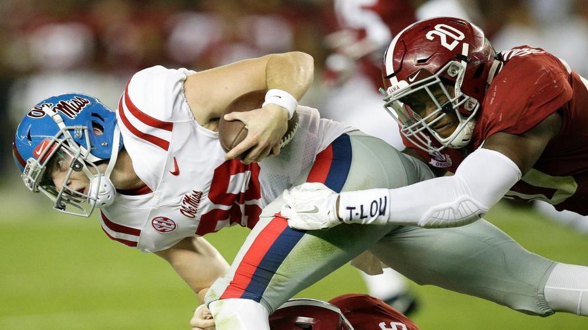 Ole Miss quarterback Shea Patterson is tackled by Alabama linebacker Shaun Dion Hamilton.