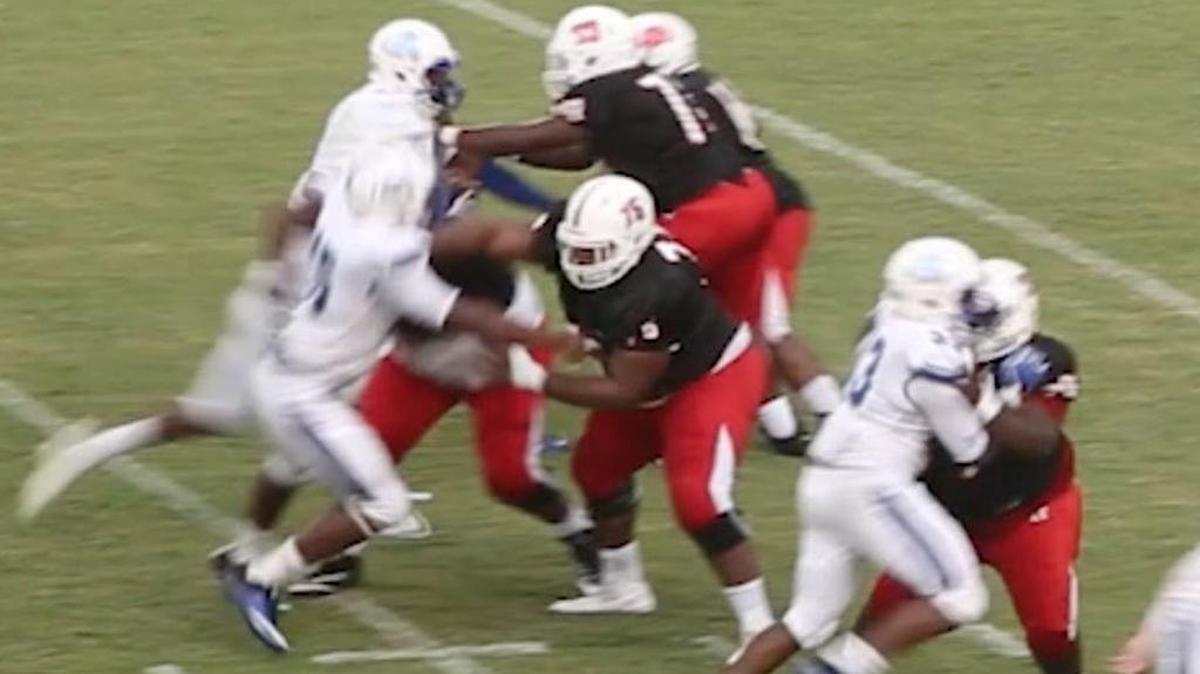 Harrison Central center Bryce Ramsey, center, makes a block against Jefferson Davis last season.