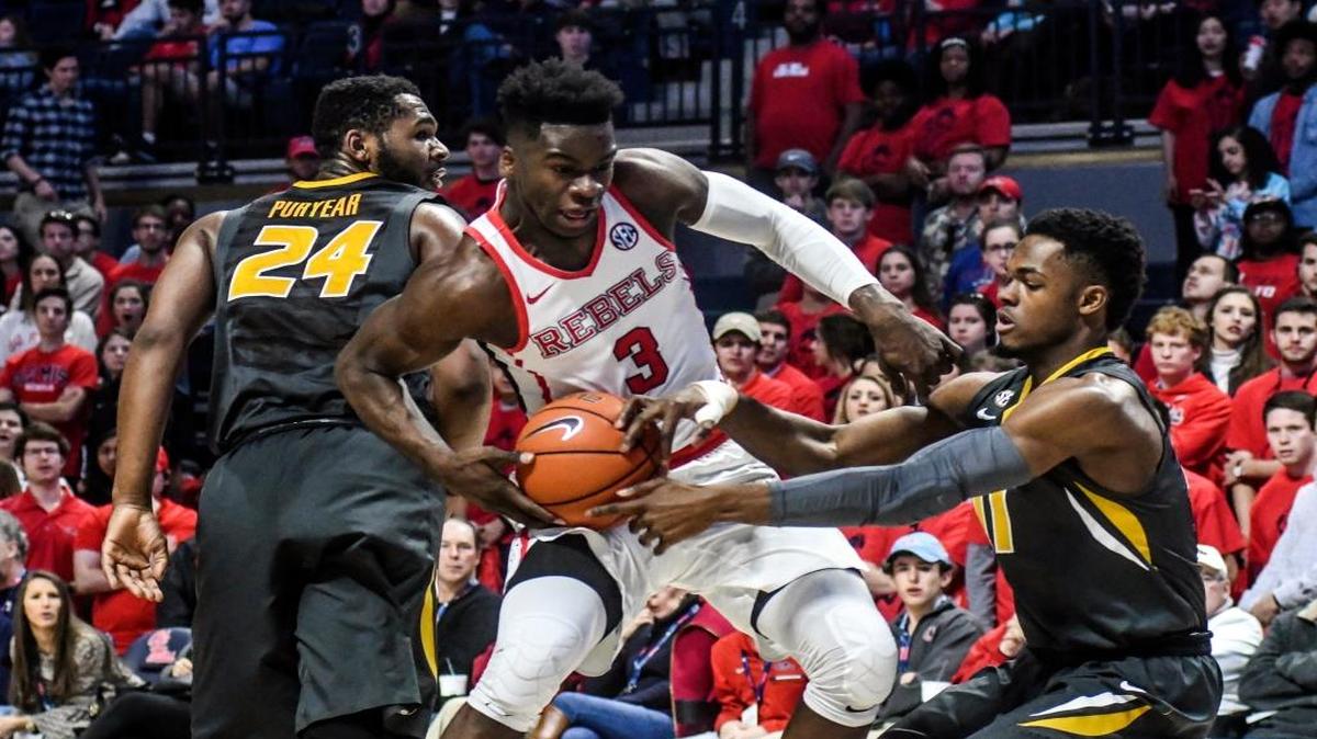Ole Miss guard Terence Davis (3) drives between Missouri's forward Kevin Puryear (24) and K.J. Walton (11) at The Pavilion.