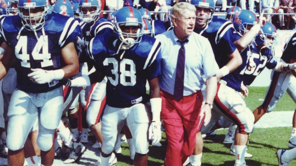 Head coach Billy Brewer prepares to lead the Ole Miss Rebels onto the field. The former head coach died Saturday after an illness. He was 83.