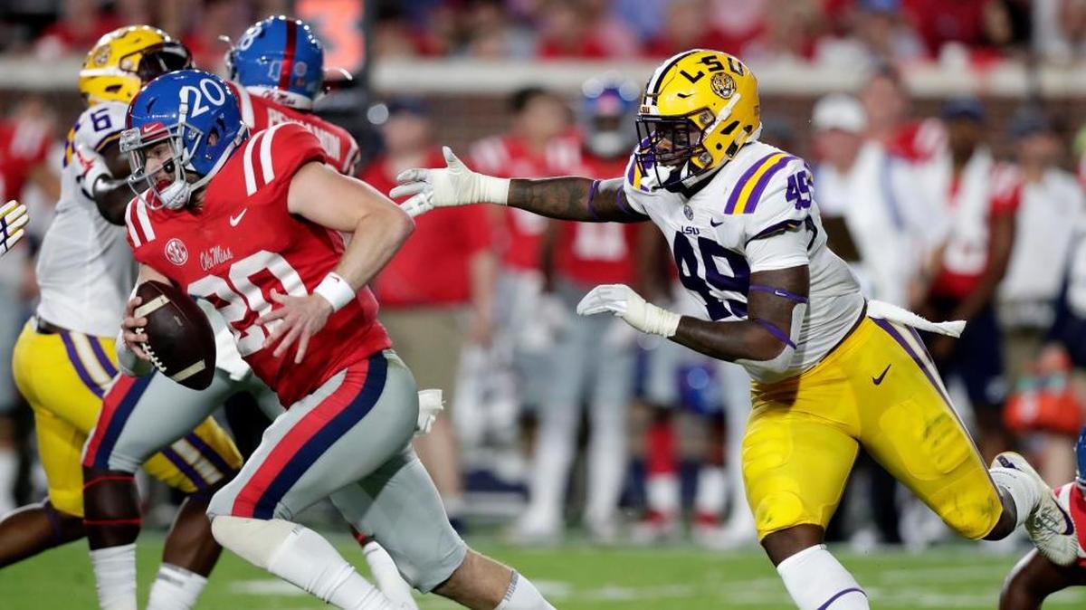 Ole Miss quarterback Shea Patterson (20) is chased out of the pocket by LSU linebacker Arden Key (49).