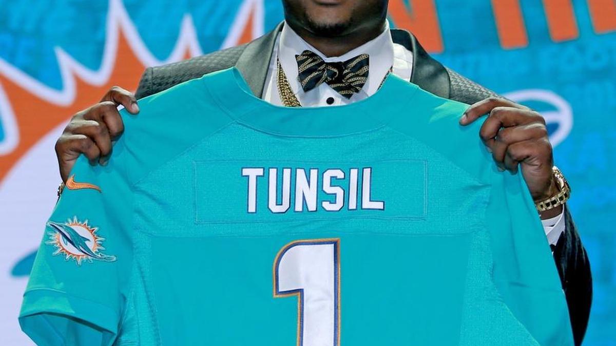 Mississippi’s Laremy Tunsil poses for photos after being selected by the Miami Dolphins as the 13th pick in the first round of the 2016 NFL football draft, Thursday, April 28, 2016, in Chicago.