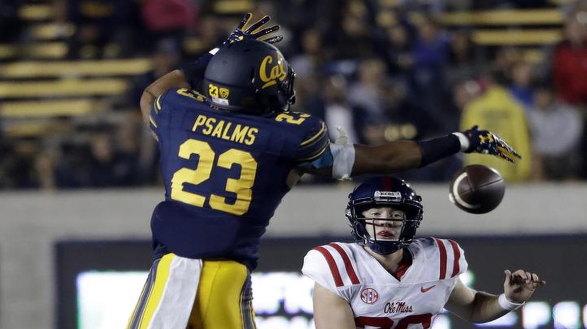 Ole Miss quarterback Shea Patterson, right, throws as California linebacker Malik Psalms (23) defends Saturday in Berkeley, Calif.