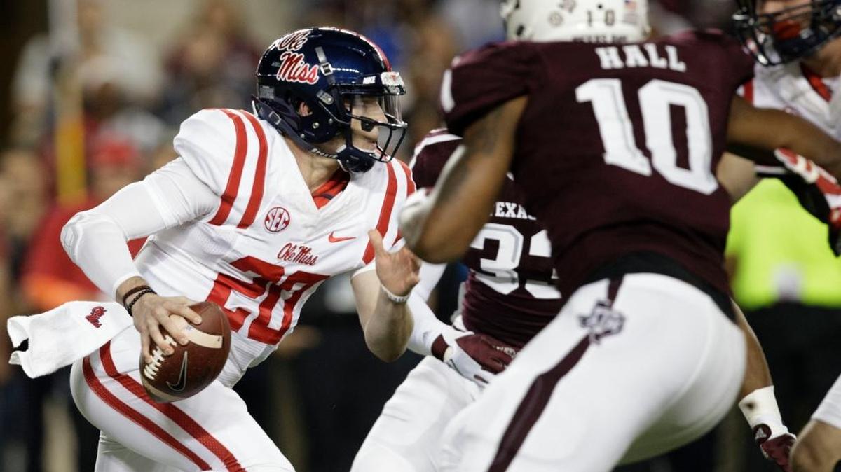 Ole Miss quarterback Shea Patterson (20) runs through the line for yards against Texas A&M.