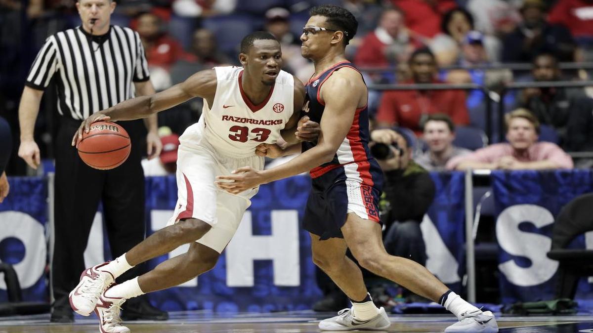 Arkansas forward Moses Kingsley (33) drives against Ole Miss forward Sebastian Saiz, right, during the second half of the SEC in Nashville.