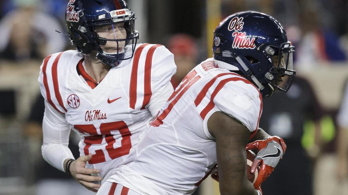 Ole Miss quarterback Shea Patterson (20) hands the ball of to running back Akeem Judd (21) during the first quarter of an NCAA college football game against Texas A&M Saturday, Nov. 12, 2016, in College Station, Texas.