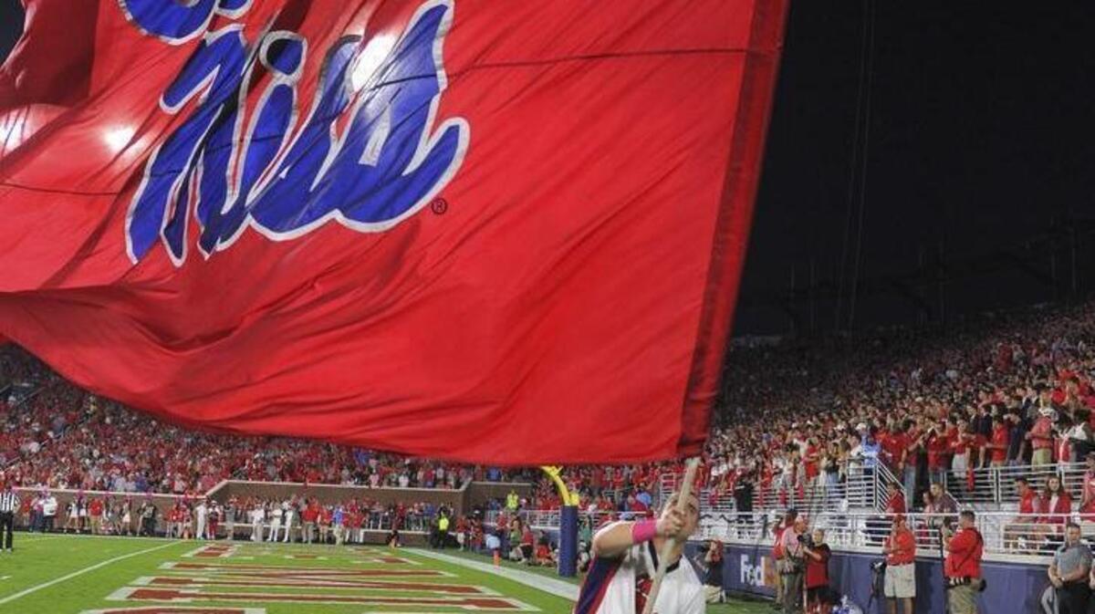 A Ole Miss cheerleader waves a flag after a Rebel touchdown against Auburn in Oxford on Oct. 29. According to a report on RebelGove.com, Ole Miss has placed one of its assistant ADs on administrative leave.