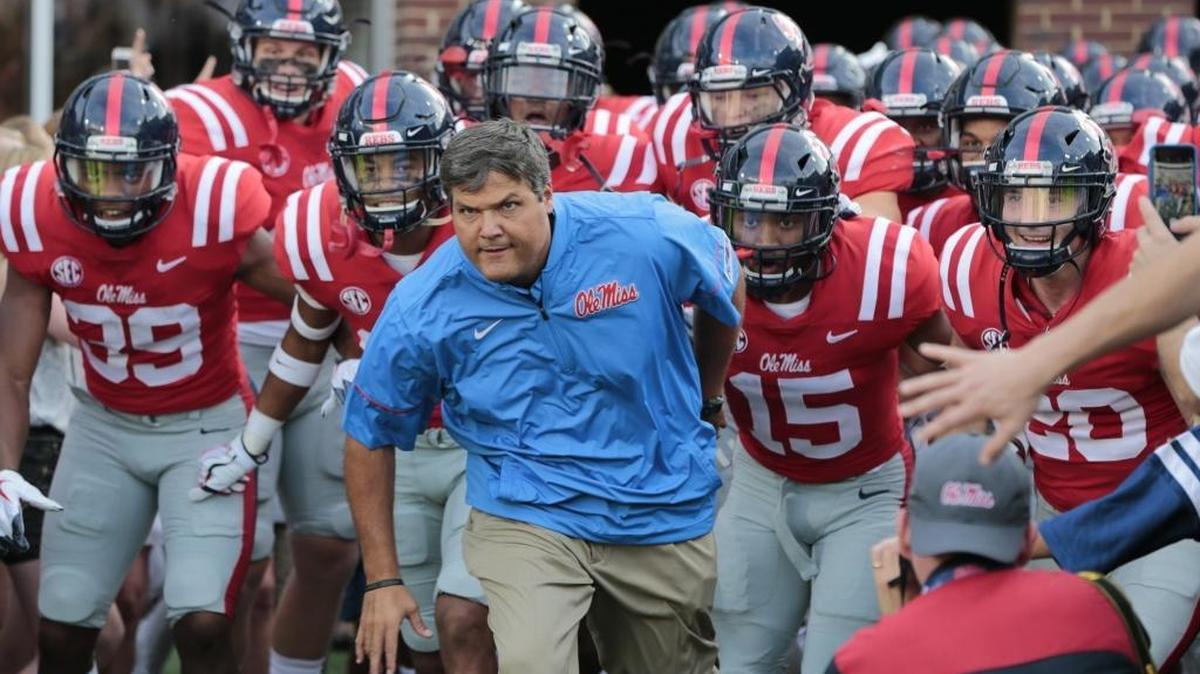 Ole Miss head coach Matt Luke leads his team onto the field before the game between Ole Miss and South Alabama at Vaught-Hemingway Stadium in Oxford on Sept. 2, 2017.