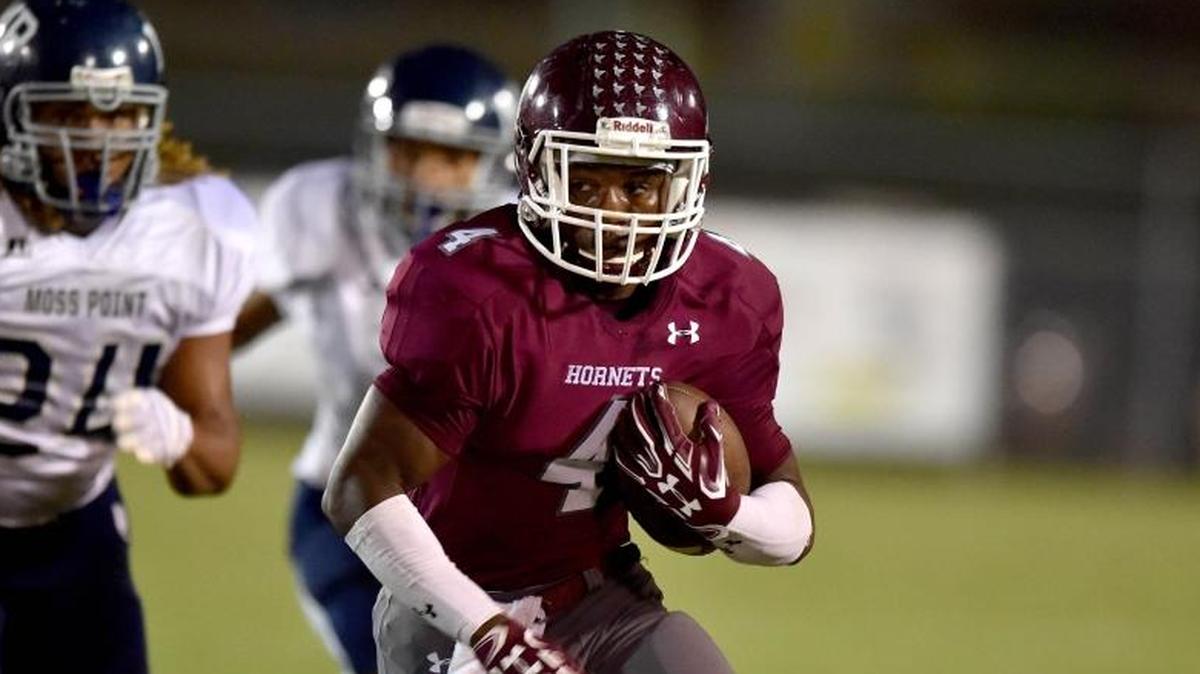 East Central running back Tony Brown (4) runs the ball against Moss Point outside linebacker Jalin Stallworth (24) on Sept. 29, 2017, at East Central High School in Hurley.