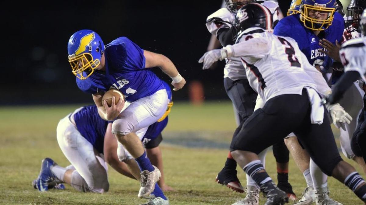 Resurrection Catholic running back Justice Sharp (21) carries the ball against Lumberton inside linebacker Davion Edwards (2) on Oct. 28 at War Memorial Stadium in Pascagoula.