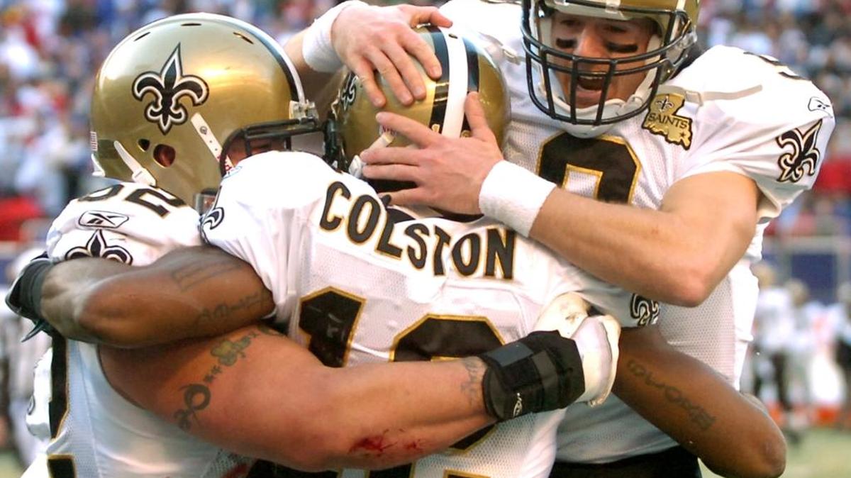 FILE - In this Dec. 24, 2006, file photo, New Orleans Saints quarterback Drew Brees, right, and center Jeff Faine, left, celebrate with wide receiver Marques Colston after Colston scored a touchdown during the second quarter of an NFL football against the New York Giants, at Giants Stadium in East Rutherford, N.J. Saints all-time leading receiver Marques Colston has been informed he'll be released by the only NFL club for which he has played during his 10-year pro career, said a person familiar with the decision says The person spoke to The Associated Press Wednesday, Feb. 24, 2016, on condition of anonymity because the move, which was first reported by ESPN, has not been announced or made official with the league office.