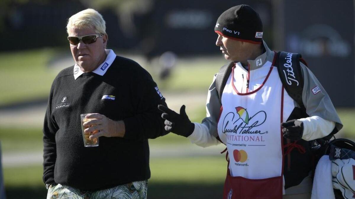 John Daly, left, talks with his caddie on the 17th green during the first round of the Arnold Palmer Invitational golf tournament in Orlando, Fla., on March 16.