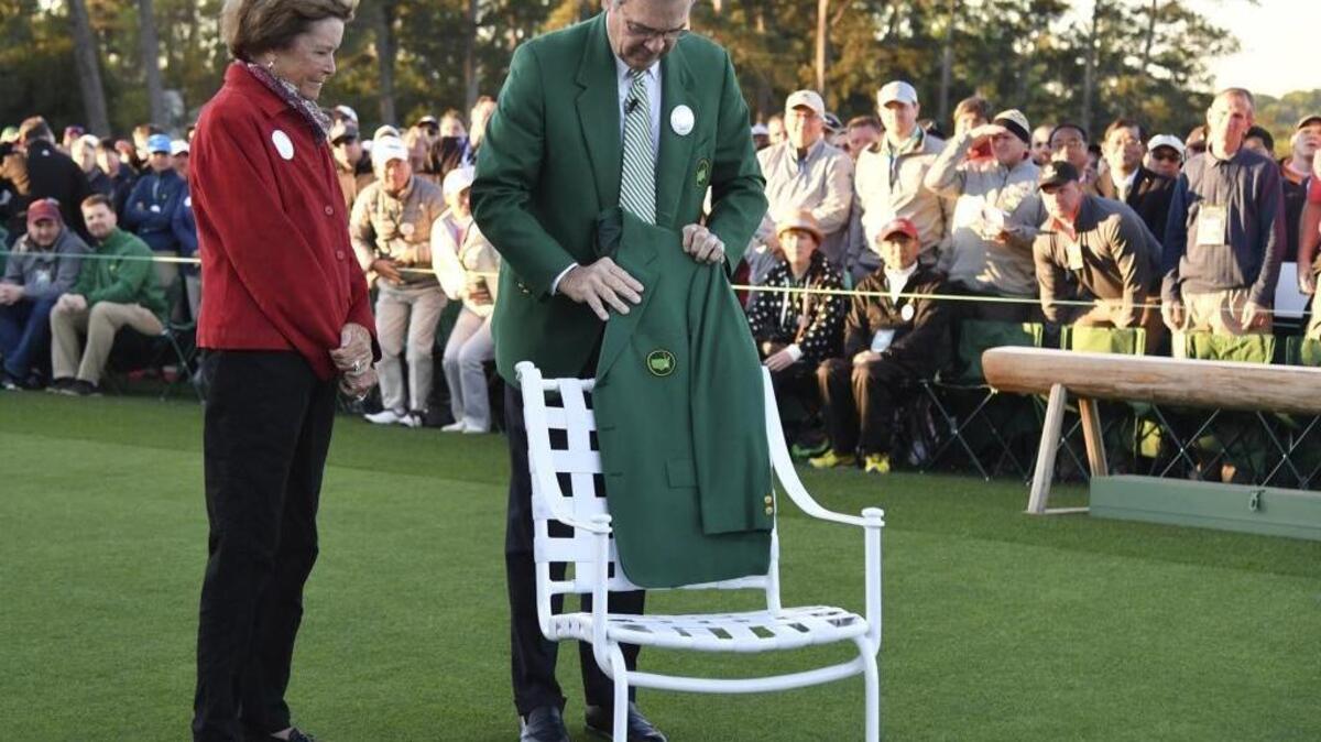 Arnold Palmer's wife, Kathleen, looks on as Augusta National Chairman Billy Payne places Palmer's green jacket on his chair at the first tee during the honorary start of the Masters golf tournament at the Augusta National Golf Club in Augusta, Ga., Thursday, April 6, 2017.