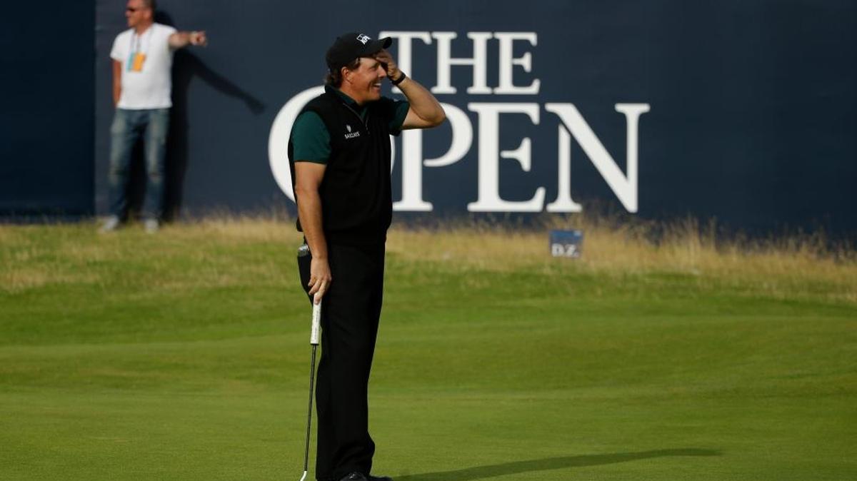 Phil Mickelson of the United States reacts as he narrowly misses a birdie putt on the 18th green during the first round of the British Open Golf Championships at the Royal Troon Golf Club in Troon, Scotland Thursday.