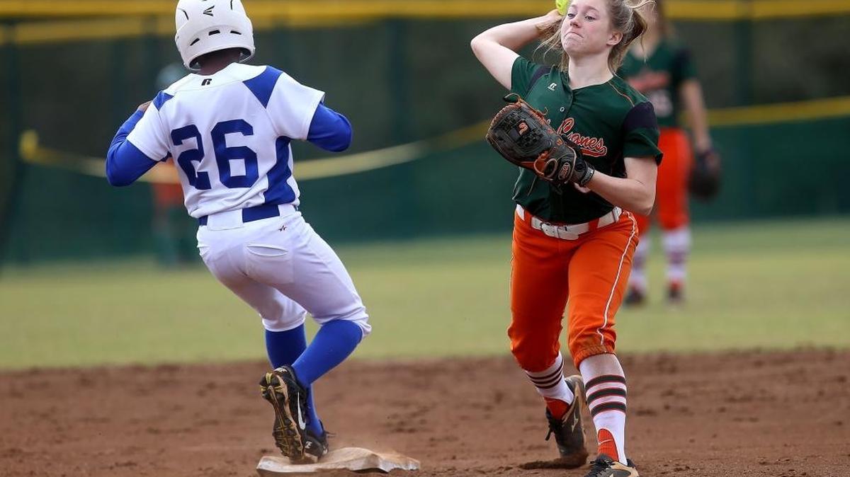 West Harrison's Marley Sims throws to first after tagging out Stone County's Yazmine Bradford during the West Harrison/Harrison Central Softball tournament on Saturday, March 11, 2017.