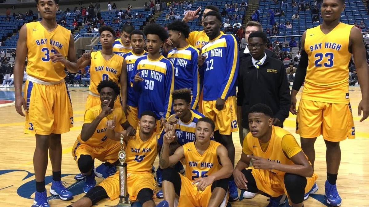 The Bay High basketball team poses with a Hoopsfest trophy after beating Biloxi Saturday at the Mississippi Coast Coliseum.