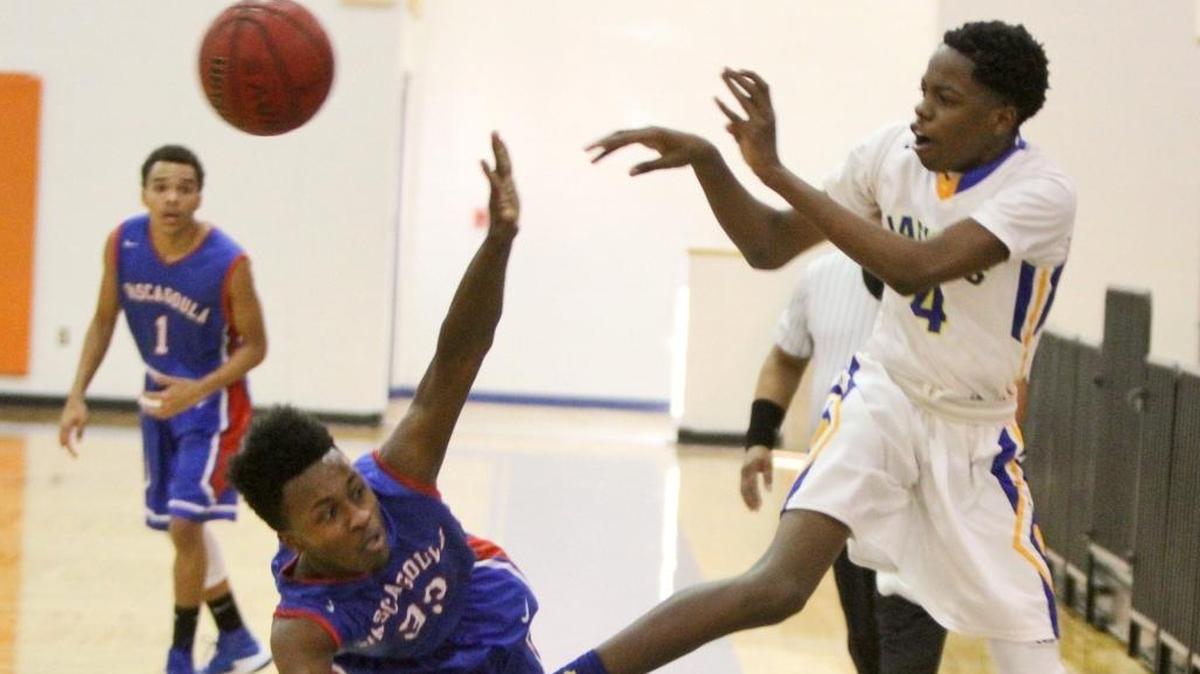 Pascagoula's Deshaun Wells tries to block St. Martin's Jaronn Wilkens' pass during the second quarter of their game in the Hardwood Holiday Classic at Bert Jenkins Gym in Gulfport on Wednesday, Dec. 28, 2016. SMHS beat Bay High on Tuesday night thanks to Wilkens’ 21-point performance.