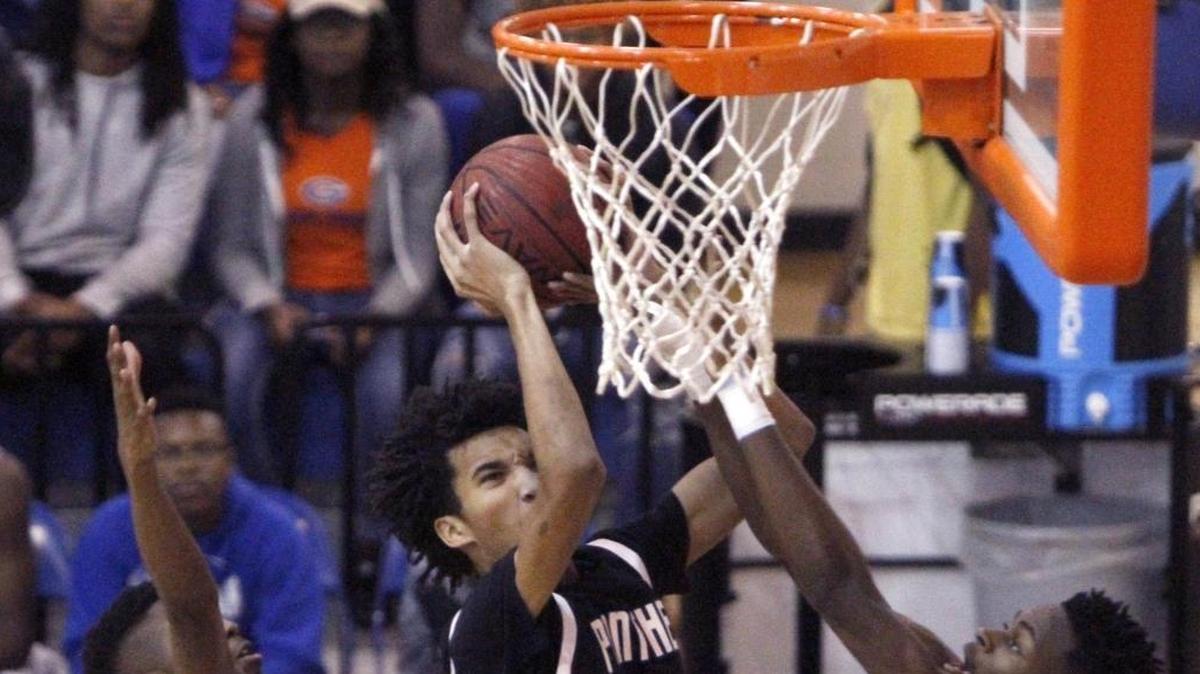 Pascagoula's Jayden McCorvey splits two Meridian defenders to take a shot during the Gulfport Hardwood Holiday Classic, Thursday, Dec. 29, 2016. McCorvey led the Panthers past Ocean Springs on Tuesday.