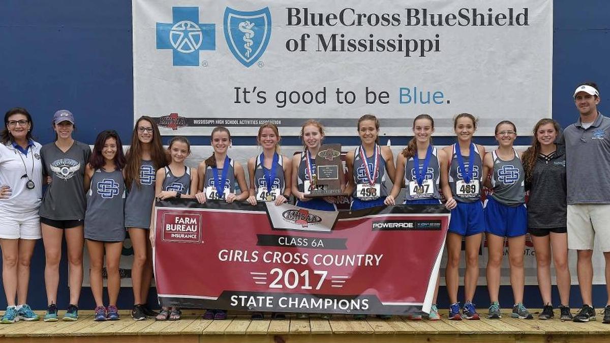 The Ocean Springs Lady Greyhounds for pictures with the Class 6A championship trophy on Saturday, November 4, 2017, in the MHSAA Class 6A-4A-2A State Cross Country Meet at Choctaw Trails in Clinton, Miss.