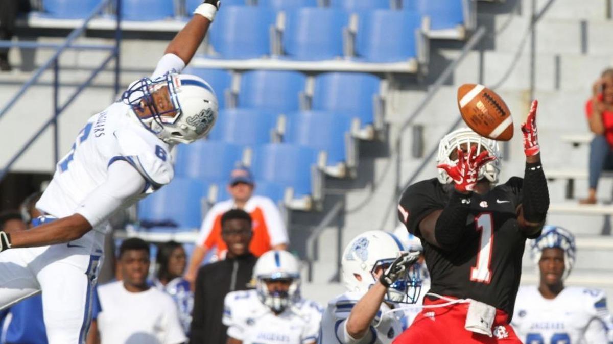 Harrison Central wide receiver Keon Moore grabs a pass over Jefferson Davis defender Jevonta Milton during the first quarter of their Port City Bowl Classic game at Milner Stadium on Gulfport on Friday, Aug. 18, 2017.