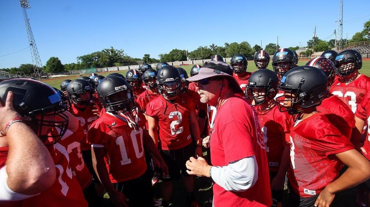 The St. Stanislaus College football team huddles up with new football coach Jeff Jordan during the first day of spring practice on Monday, May 1, 2017.