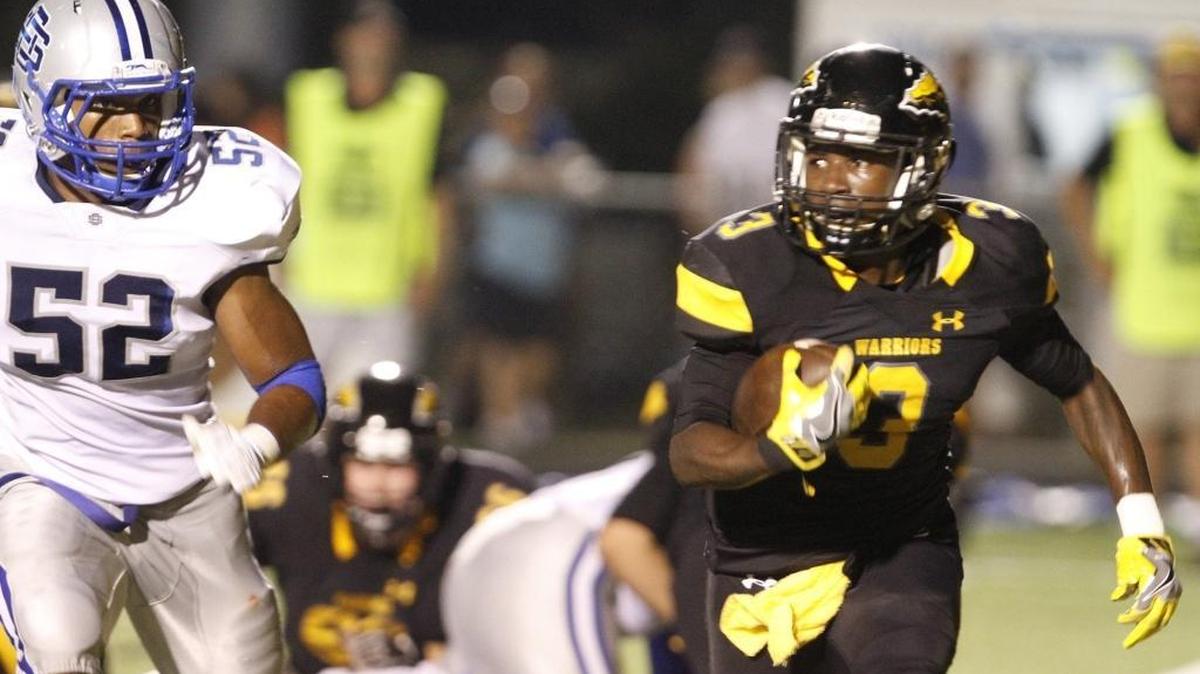 Ocean Springs defensive end Jaden Smith chases D'Iberville running back Ja'Quavis Foster during the second quarter of their game at Warrior Stadium in D'Iberville on Friday, Sept. 29, 2017. Pascagoula traveled to D’Iberville on Friday.
