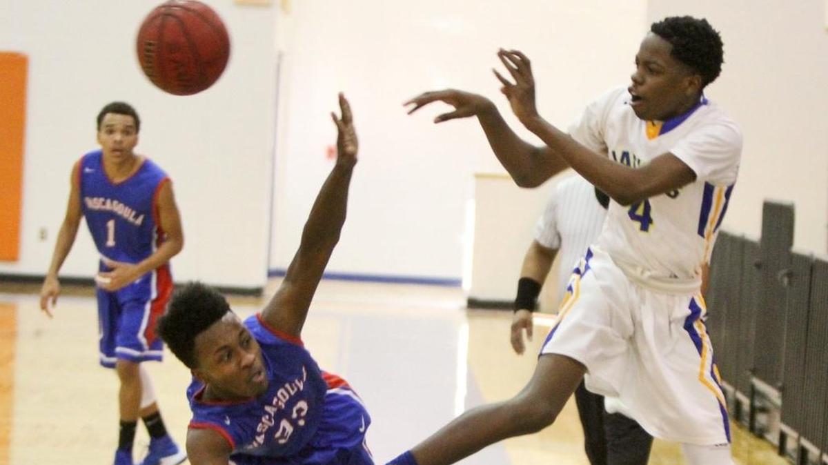 Pascagoula's Deshaun Wells tries to block St. Martin's JaRonn Wilkens' pass during the second quarter of their game in the Hardwood Holiday Classic at Bert Jenkins Gym in Gulfport on Wednesday, Dec. 28, 2016.