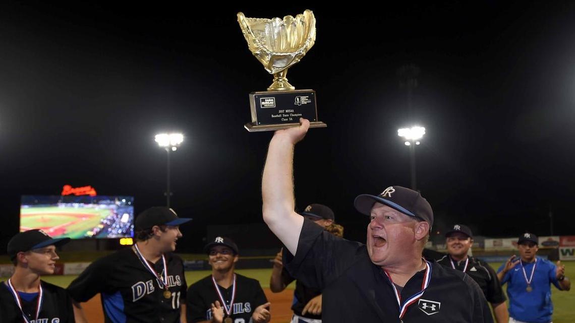 Pearl River Central head coach Neil Walther shows the Class 5A trophy to the fans on Saturday, May 20, 2017, in the MHSAA State Baseball Championships at Trustmark Park in Pearl, Miss.