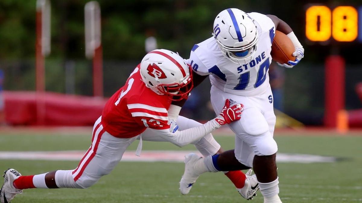 Biloxi's Mondre Stewart holds on to Stone County's Trey Arrington as he runs the ball on Friday at Biloxi High.