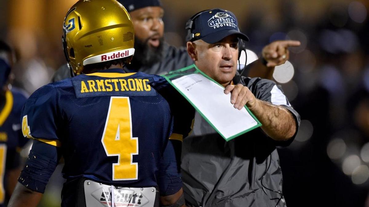 Gautier head coach Chris Peterson congratulates middle linebacker Nicholas Armstrong after an interception against Pascagoula on Sept. 8 in Gautier.