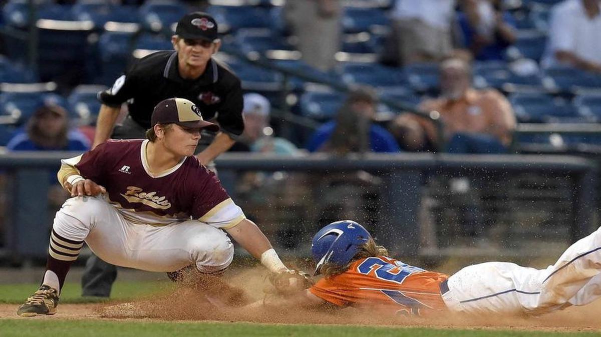 George County's Logan Tanner tags out Madison Central's Micah Fairley at third base on May 19, 2016 in the Class 6A State Baseball Championship at Trustmark Park. The Rebels beat Biloxi 11-0 on Thursday.