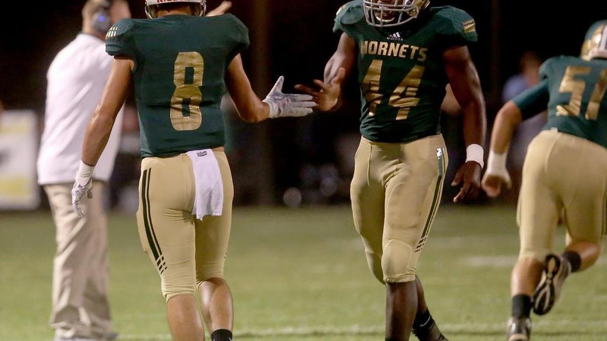 Poplarville’s Tyson Holston, left, and Mario Barnes high-five after the Hornets scored a touchdown against Greene County on Friday, September 29, 2017, at Poplarville High. Poplarville hosted Northeast Lauderdale on Friday to open the MHSAA Class 4A playoffs.