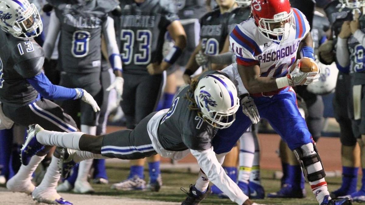Stone's Enrique Whaley knocks Pascagoula running back Javarous Walker out of bounds during the first quarter of their game at A.L. May Memorial Stadium in Perkinston on Friday, Sept. 30, 2016. Pascagoula won 19-17.