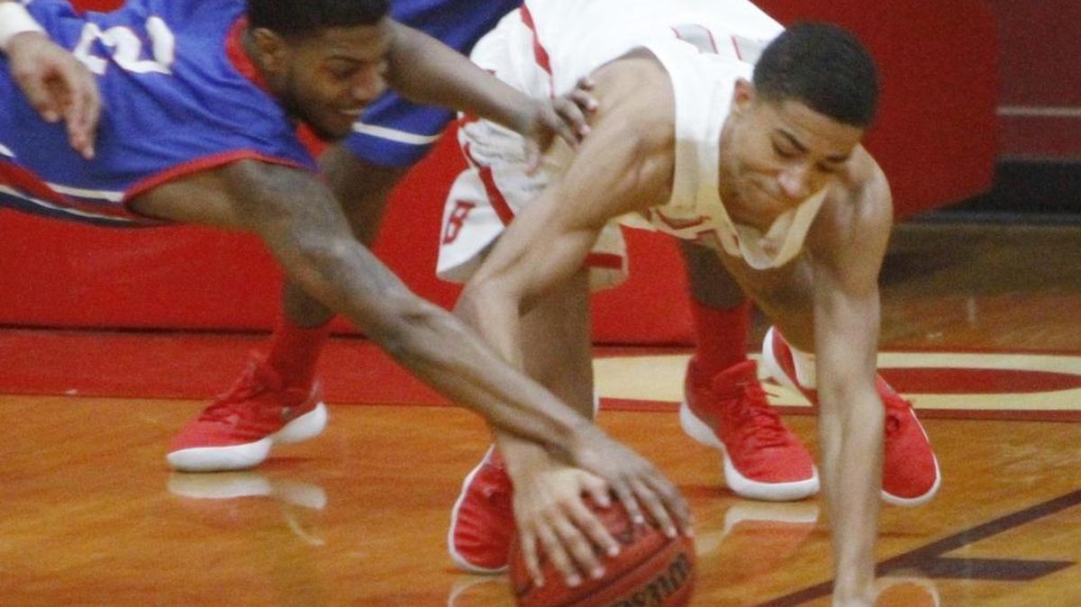 Pascagoula's Deante Parker and Biloxi's Roshaun Jones dive for a loose ball during the second quarter of their game at the Biloxi High gym on Tuesday, Dec. 3, 2017.