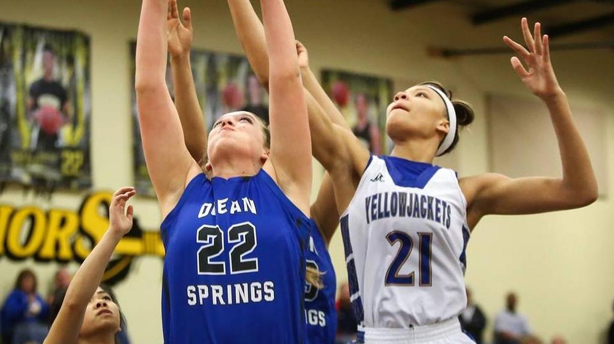 Ocean Springs' Dougless St. Amant, center, gets her hands on a rebound while surrounded by St. Martin's Ashley Pham, left, and Daphne White on Friday, Feb. 19, 2016, at D'Iberville High. White is nearly averaging a triple double this season.