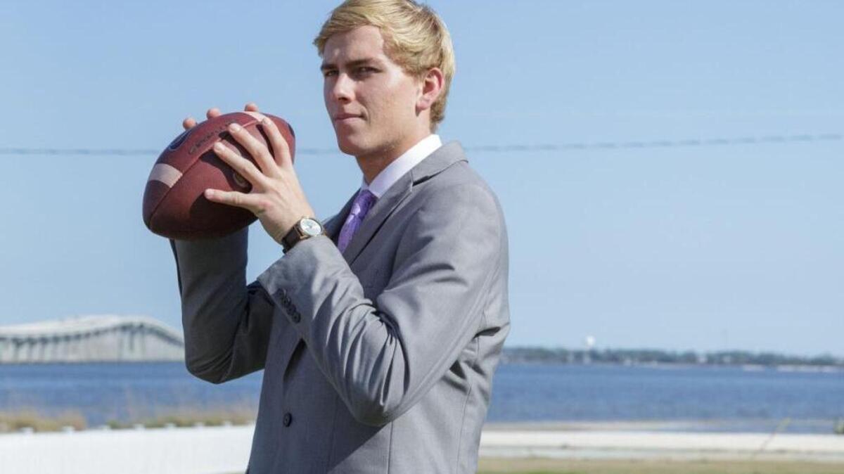 Myles Brennan gets ready to throw a football with a family friend on a plot of land where his family home once stood in Bay St. Louis. Destroyed during Hurricane Katrina in 2005, the Brennans' family home that overlooked the Bay of St. Louis was never rebuilt.