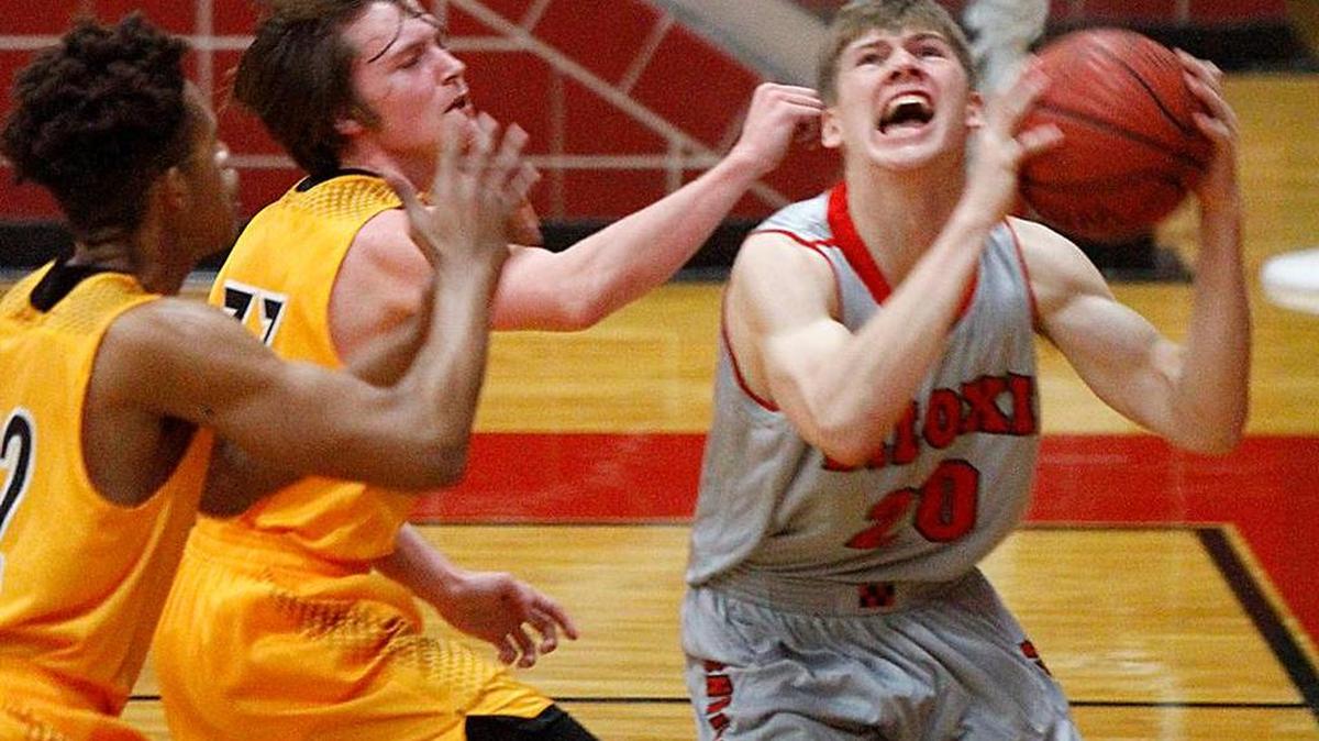 Biloxi's Michael Burbridge drives the baseline against D'Iberville's Chris Weary and Kyle Winters, Wednesday, Feb. 24, 2016. Biloxi opens the year as the Sun Herald’s top boys basketball team.