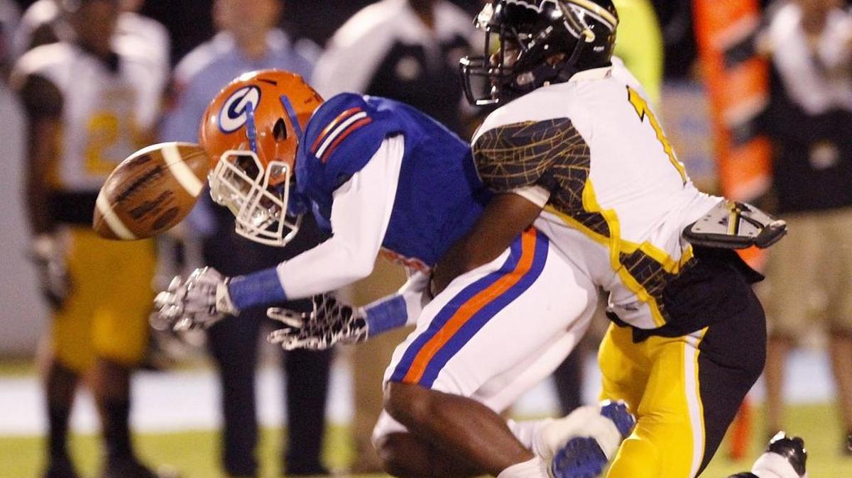 Gulfport's Jalen Knight loses grip on the ball after it is knocked from his grasp by D'Iberville's D. J. Polk at Milner Stadium, Friday Oct. 21, 2017.