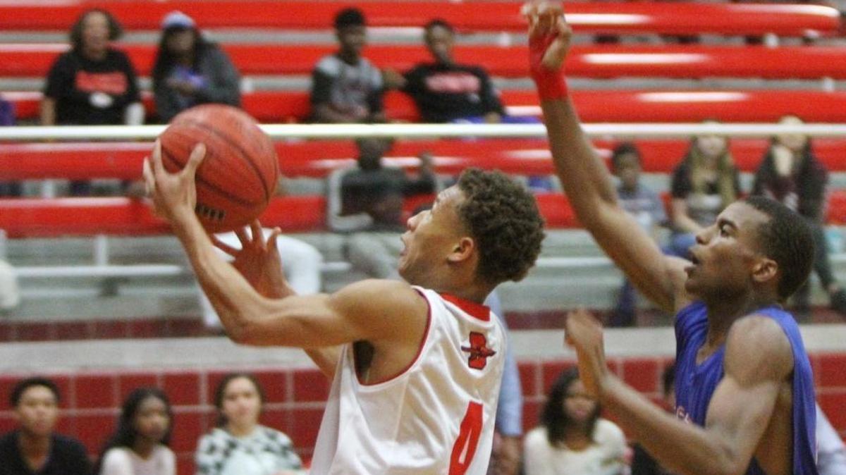Biloxi's Dontavius Proby drives to the basket past Pass Christian's Aydarius Young during the first quarter of their game at Biloxi High School on Tuesday, Dec. 13, 2016. Biloxi cruised past Gulfport on Friday to push their record to 15-0.