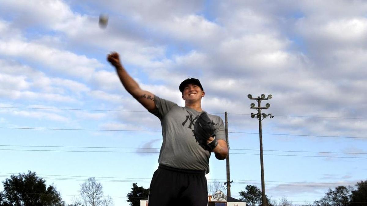 Jonathan Holder tosses baseball with Ethan Saucier at Gulfport Admirals baseball field. Along with other baseball players, Holder is hosting a youth baseball clinic Saturday at St. Patrick with the proceeds going to two local youths who are currently battling cancer.