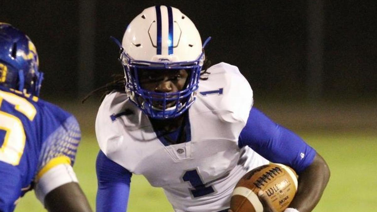 Ocean Springs quarterback Malcolm Magee hits a hole during the first quarter of their game against St. Martin at Joe Barlow Stadium in St. Martin on Oct. 21, 2016.