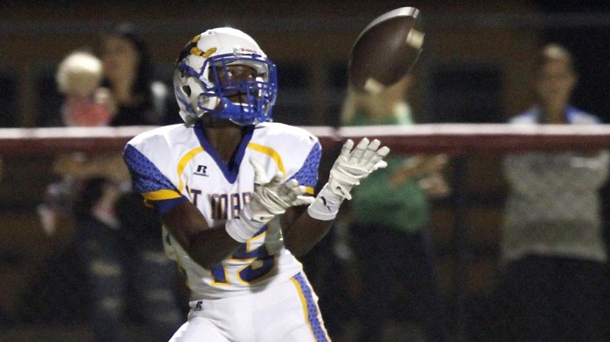 St. Martin receiver Quan Walley catches a long pass for a touchdown from quarterback Wayne Overman III during game against Harrison Central.