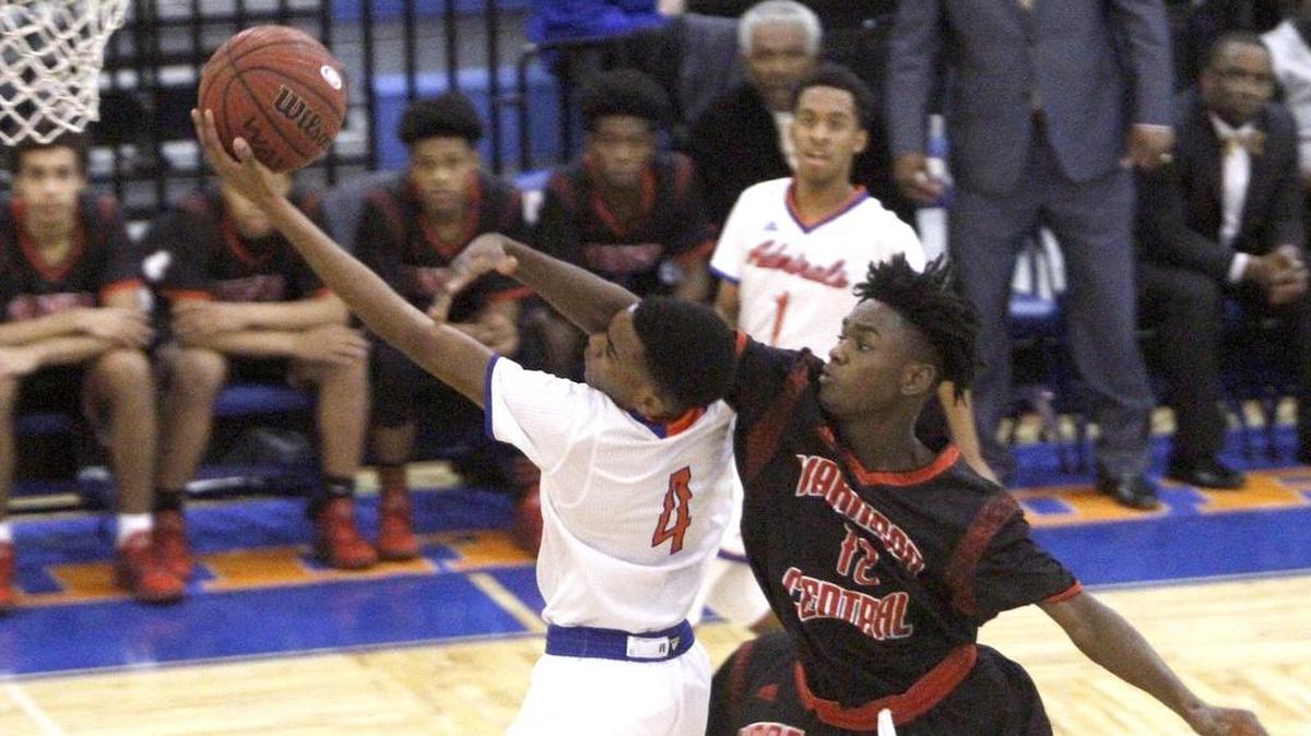Harrison Central's Anthony Barnett catches Gulfport's Keevon Oney in the face while trying to block a shot Friday at Gulfport.