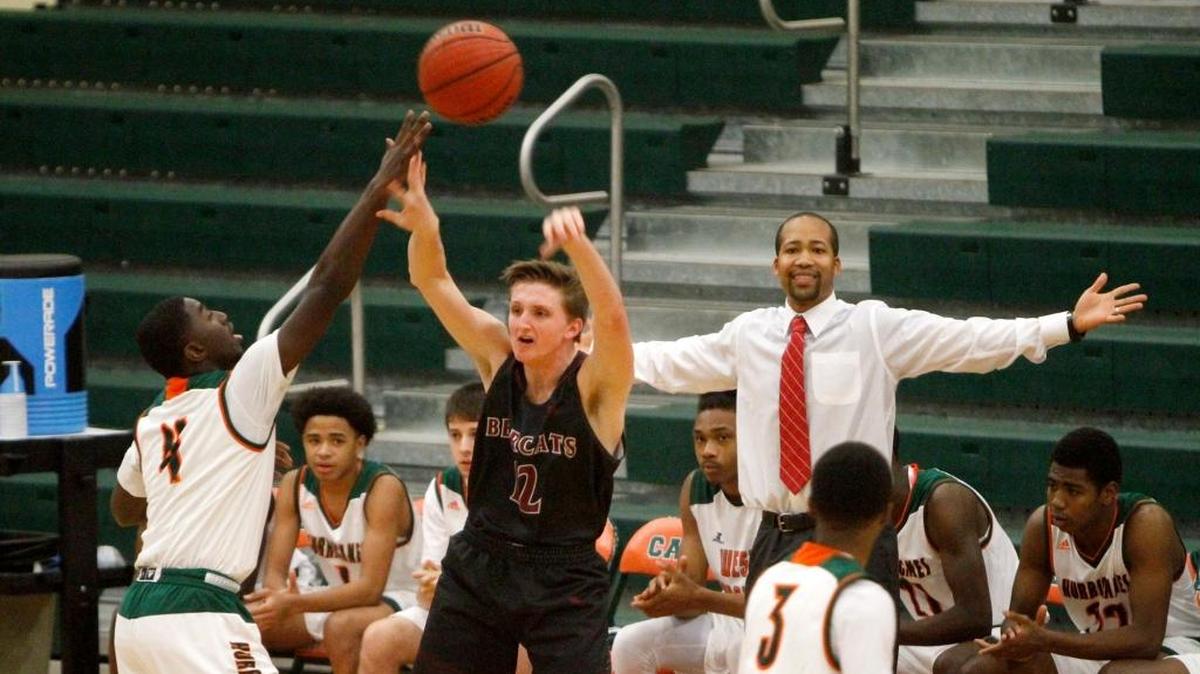 West Harrison coach Tommy Searight watches as Quieran Gray blocks the pass of Long Beach’s Eli Dykes on Feb. 14.