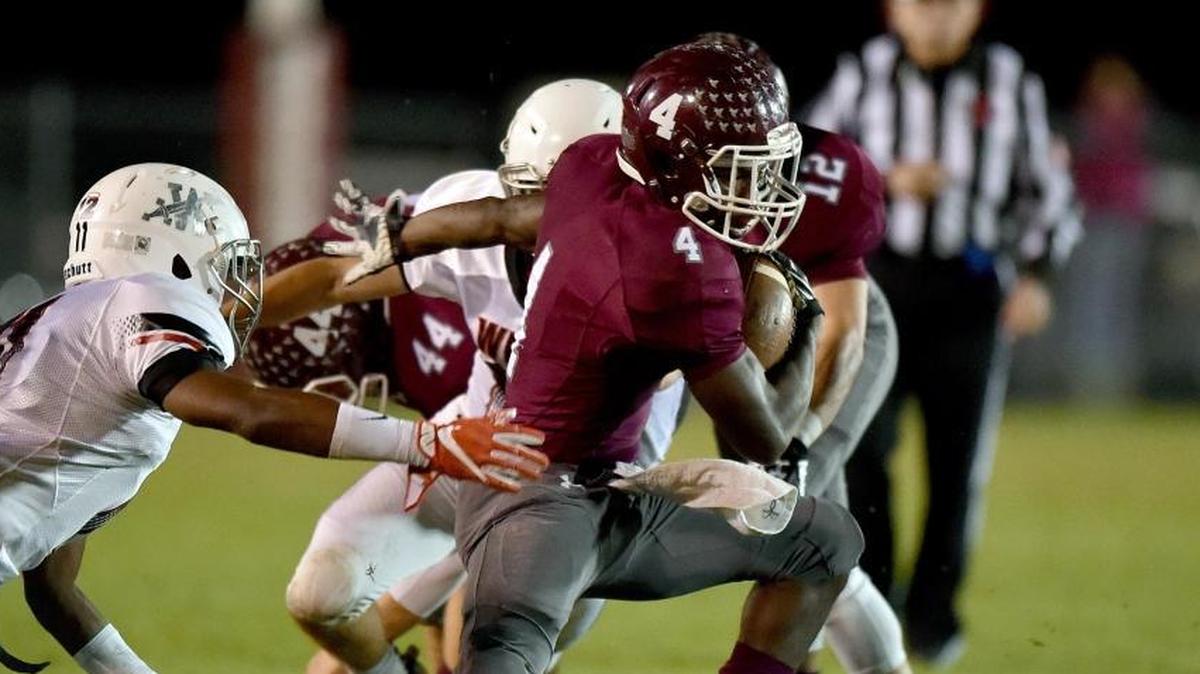 East Central running back Tony Brown (4) runs the ball against West Lauderdale free safety TJ Hersey (left) and linebacker Parker Yudt (right) on Nov. 10 in Hurley.