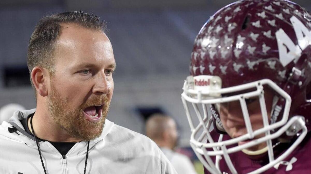 East Central head coach Seth Smith tries to get his players up during Saturday’s game against Noxubee County in Oxford.