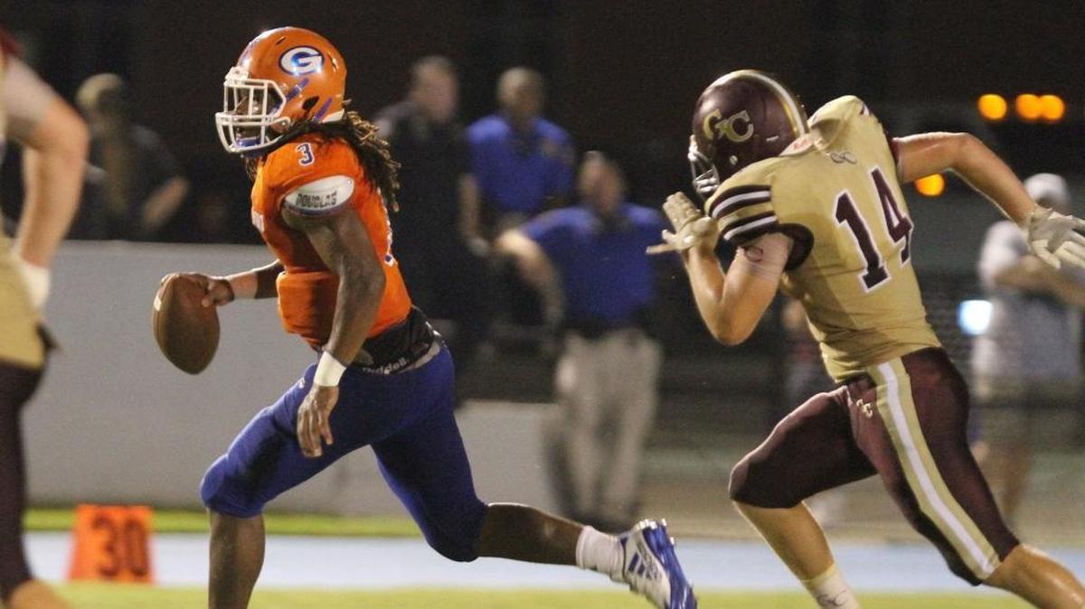 George County’s Luke Thompson chases Gulfport quarterback T.Q. Newsome during the second quarter of their Port City Bowl Classic game at Milner Stadium in Gulfport on Aug. 18, 2017.