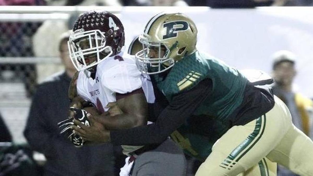 East Central running back Tony Brown carries a Poplarville tackler on a long run during the second quarter of their 4A South State championship game at Poplarville High School Stadium on Friday, Nov. 24, 2017.
