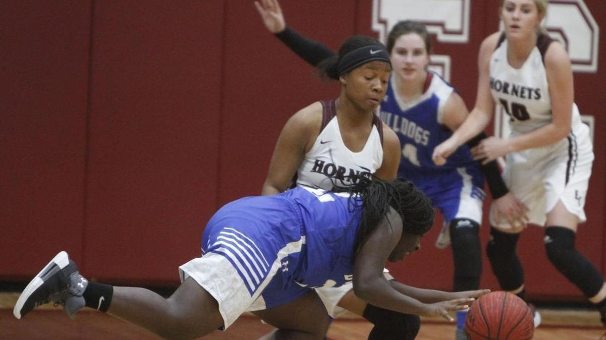 Vancleave's Khadeejah Franklin stumbles as she dribbles against East Central's Sania Wells during the first half of their game at East Central gym in Hurley on Friday, Dec. 15, 2017.
